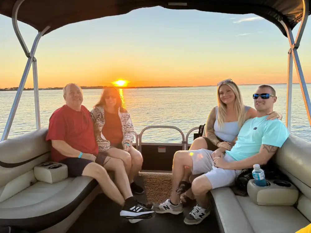 Family enjoying a Destin sunset cruise together on calm waters